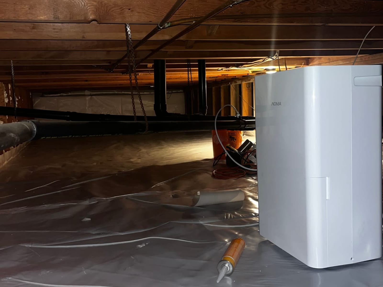 Dehumidifier standing on the finished vapour barrier in a sealed crawlspace